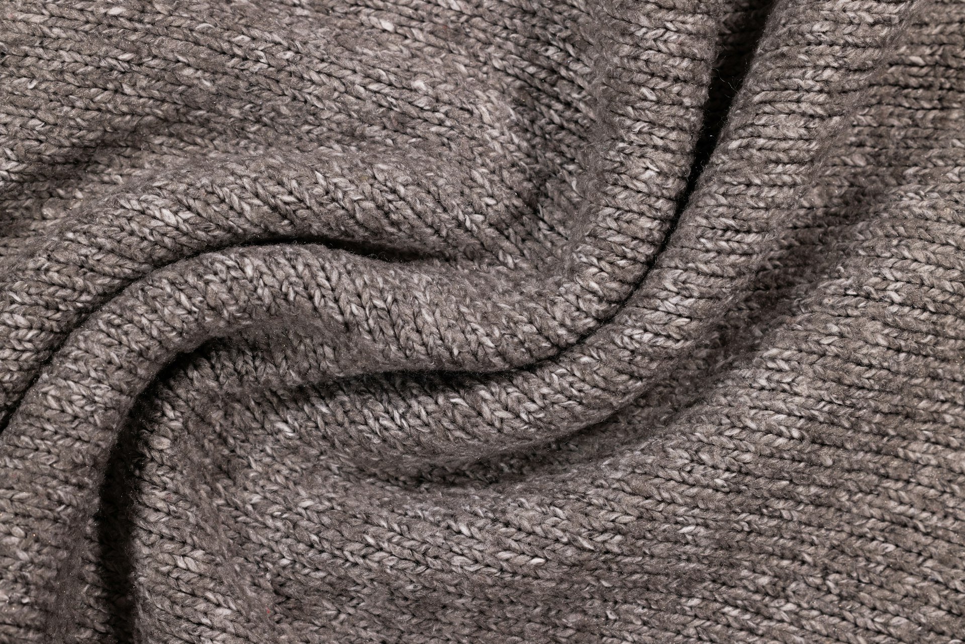 a close up view of a gray sweater